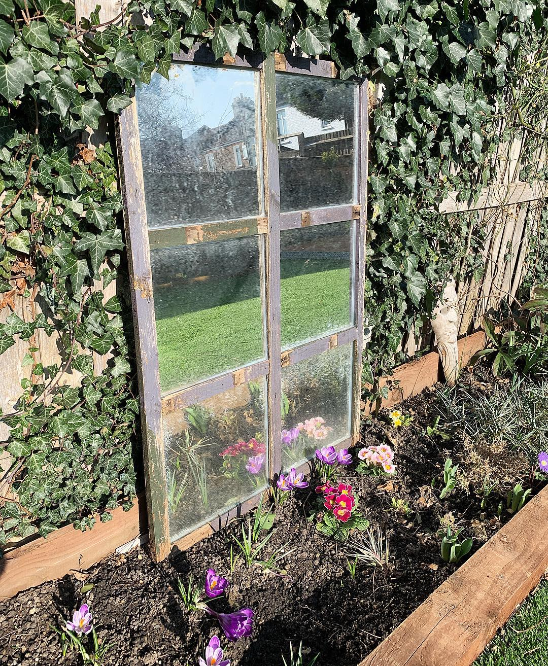 This window still has glass where it is even in the form of a mirror. It is unique because this kind of window decoration for the junk garden is rare to have.