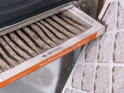Replacing dirty furnace filter in home