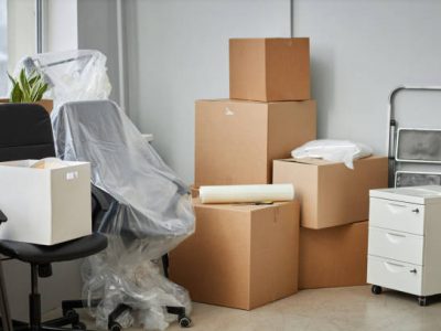 Relocation to a new office with packed cardboard boxes and furniture