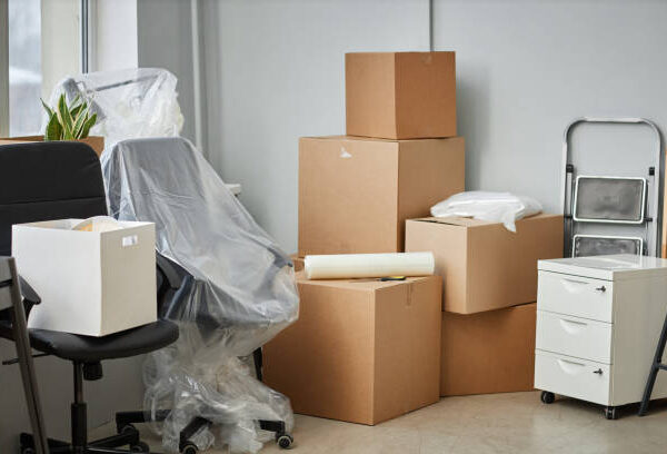 Relocation to a new office with packed cardboard boxes and furniture