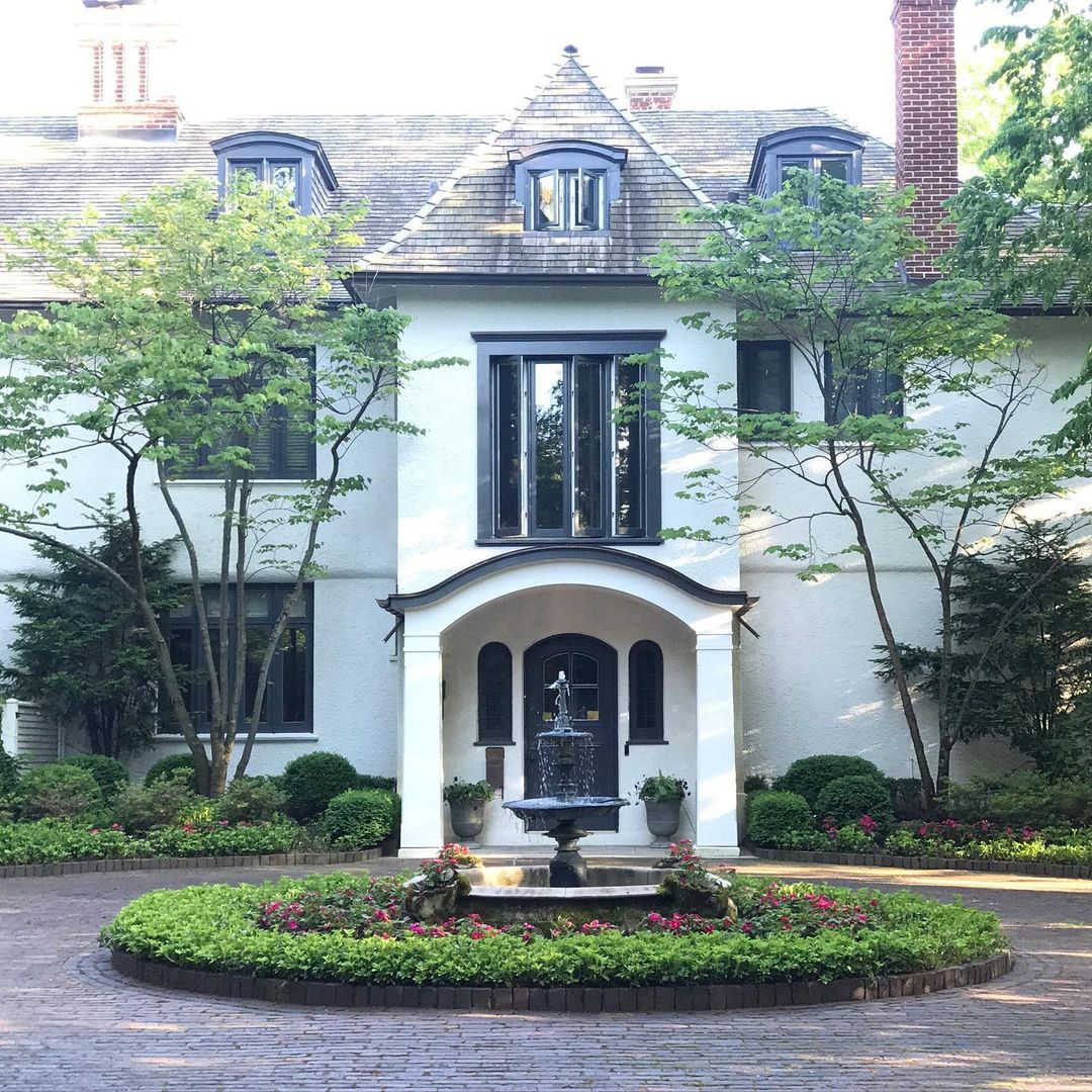 The water fountain is installed in the center of the front yard landscape.