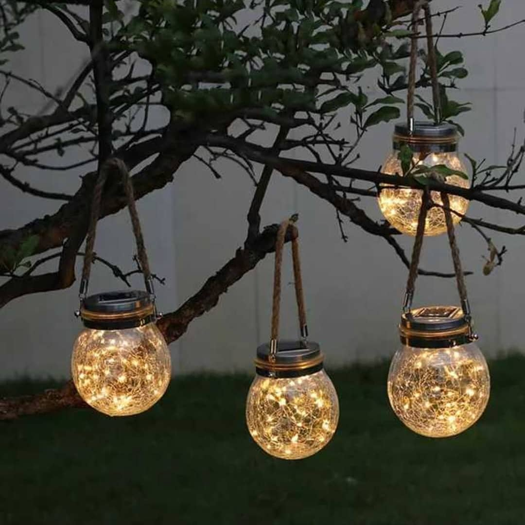 It is made of a glass jar which is filled with fairy light. You can hang it on a small tree since the size is small.