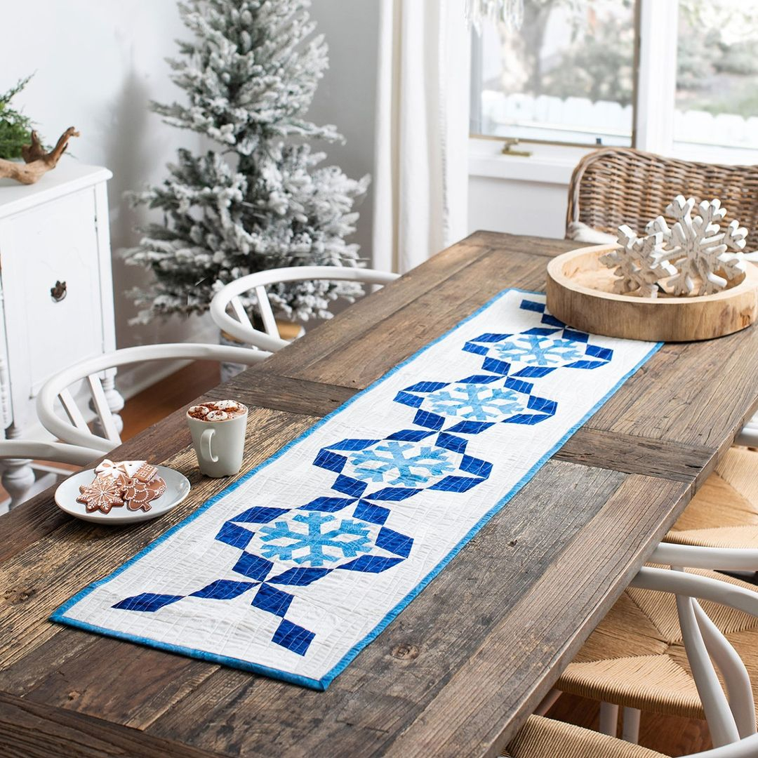 This table runner has a white color as the base. Then, it uses a blue color for the pattern.