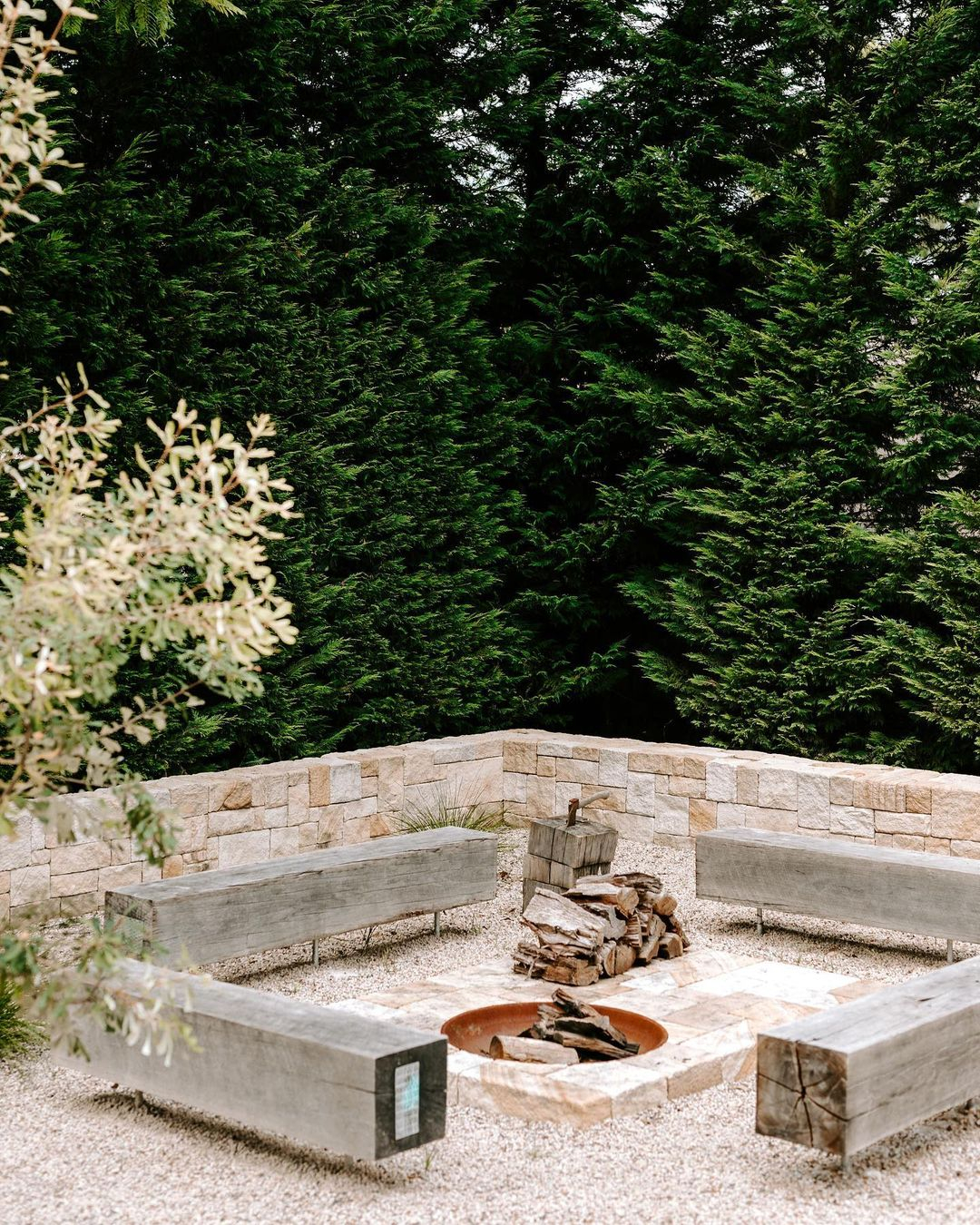 A firepit is an effective item to create an inviting atmosphere. This one is made of stone bricks with a hole in the center.