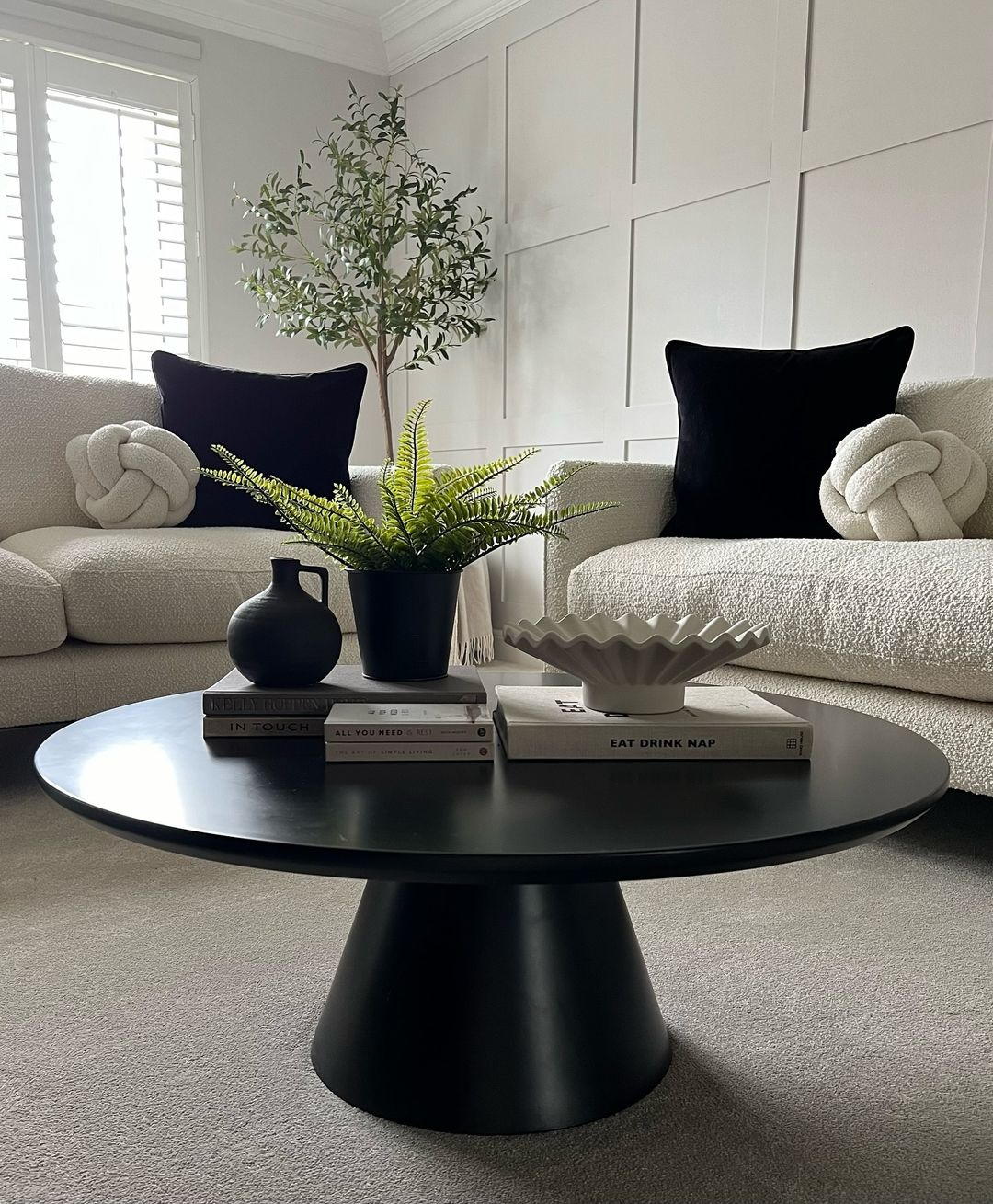 Black accents with black throw pillows and coffee table