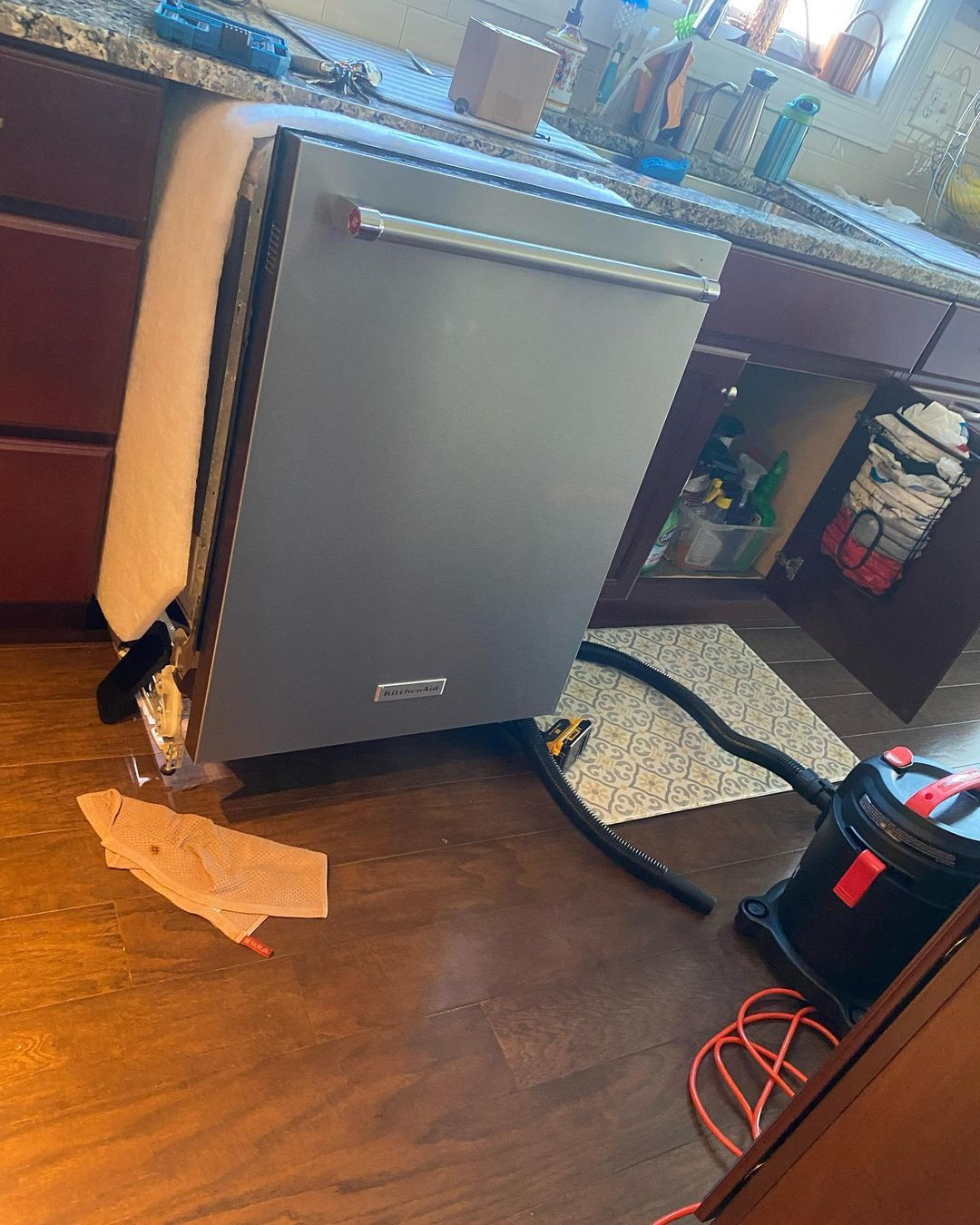 Using a vacuum cleaner is the best way to clean the debris. It can also dry the leak as well.
