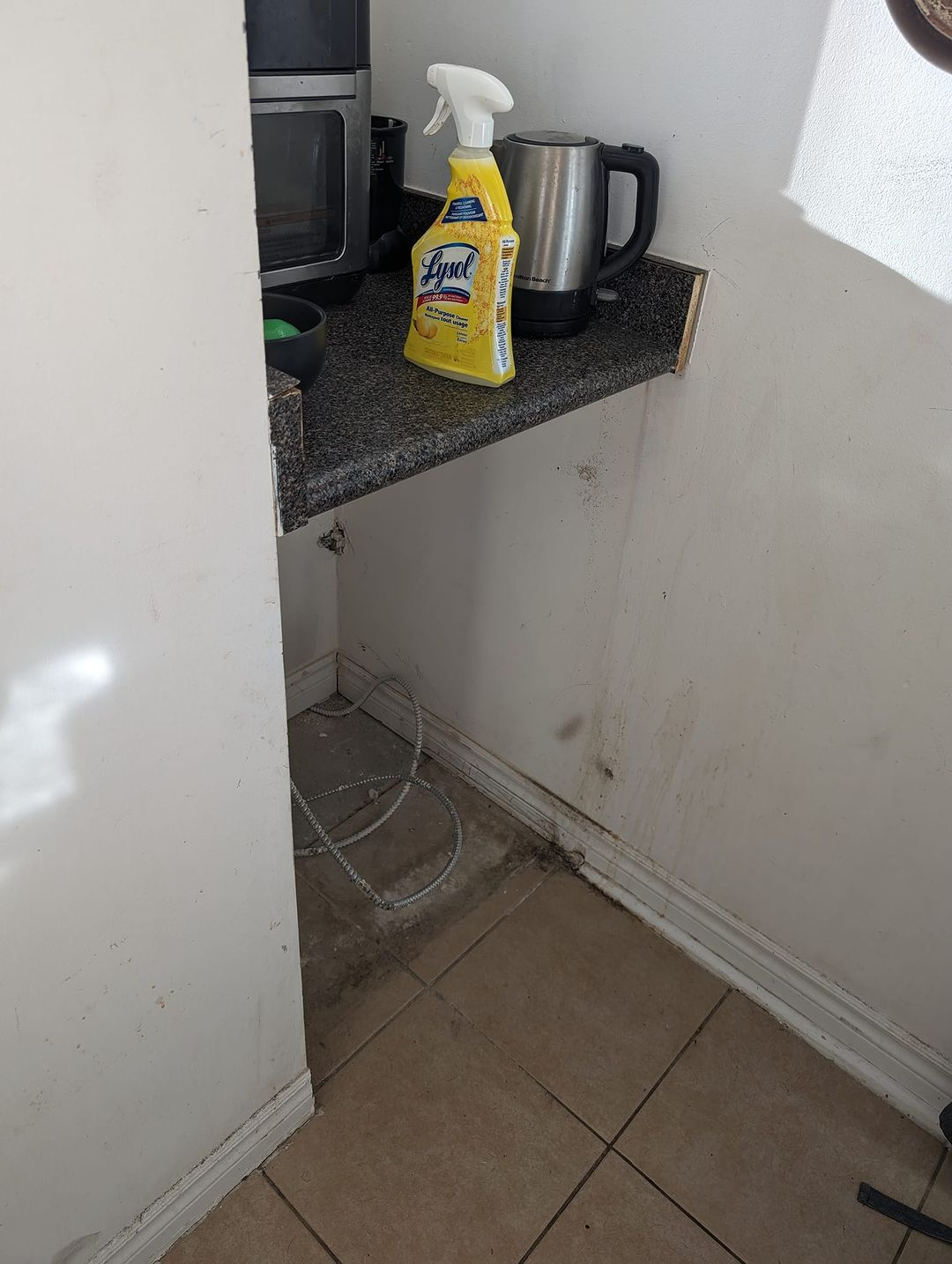 Look at how dirty the space behind and under the dishwasher. It can cause a bad smell and pests. 