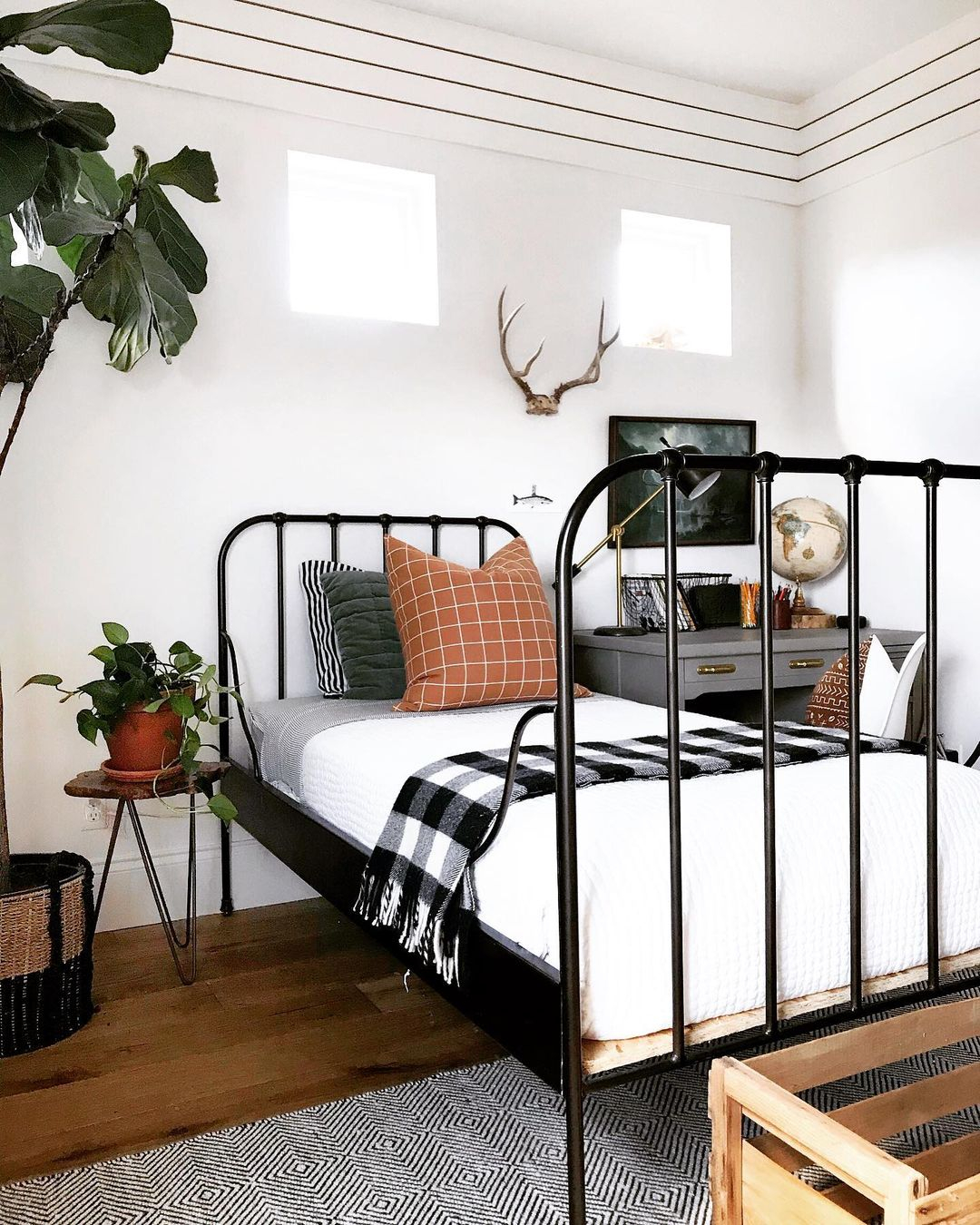 Look at the bed! It is in black color and made of metal piping. The metal material is then combined with the wood material.