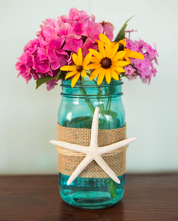 The mason jar is made to be a vase which is added with the jute for the rustic touch.