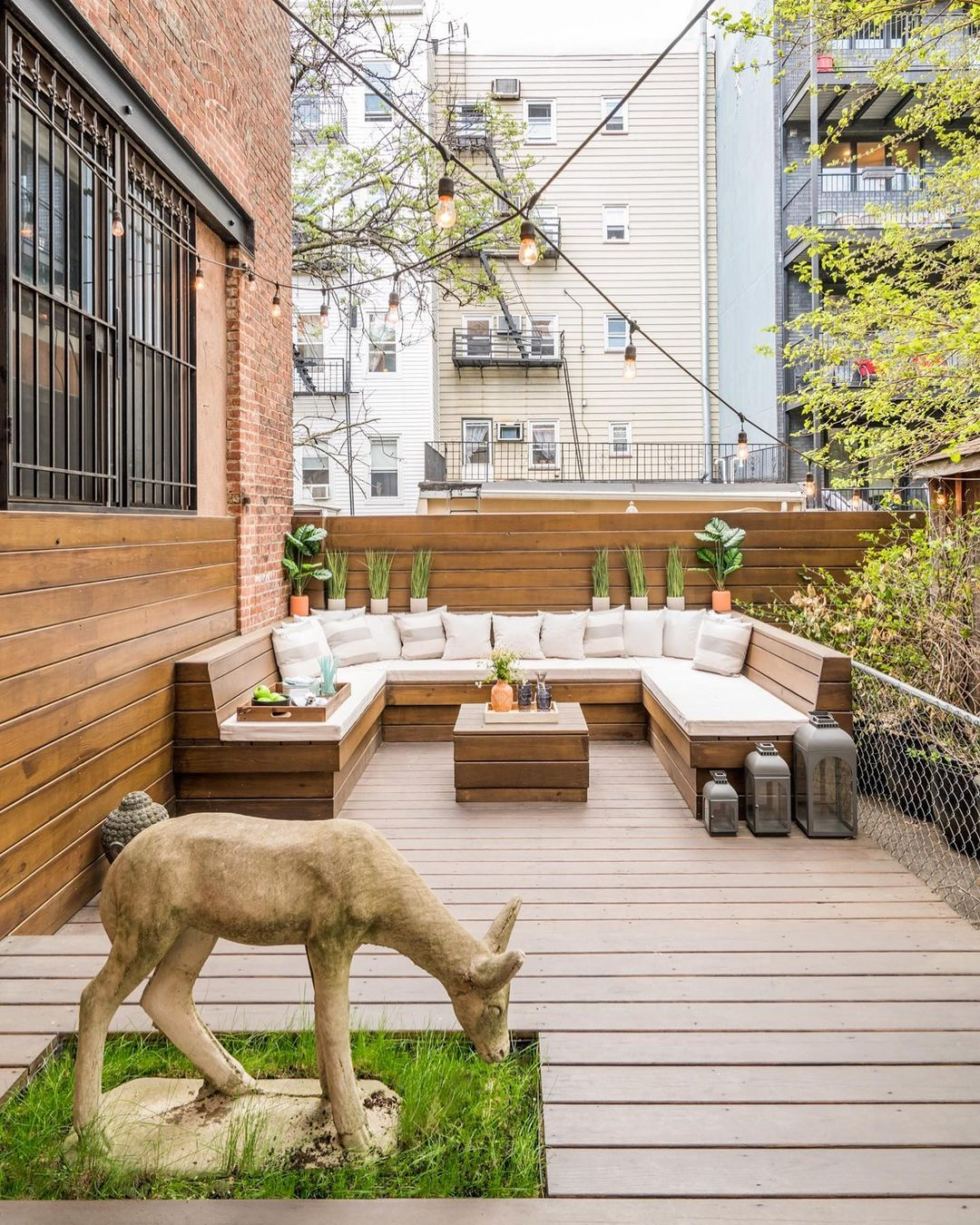 It is great how the patio still left a space on the deck area with soil and a small lawn area.