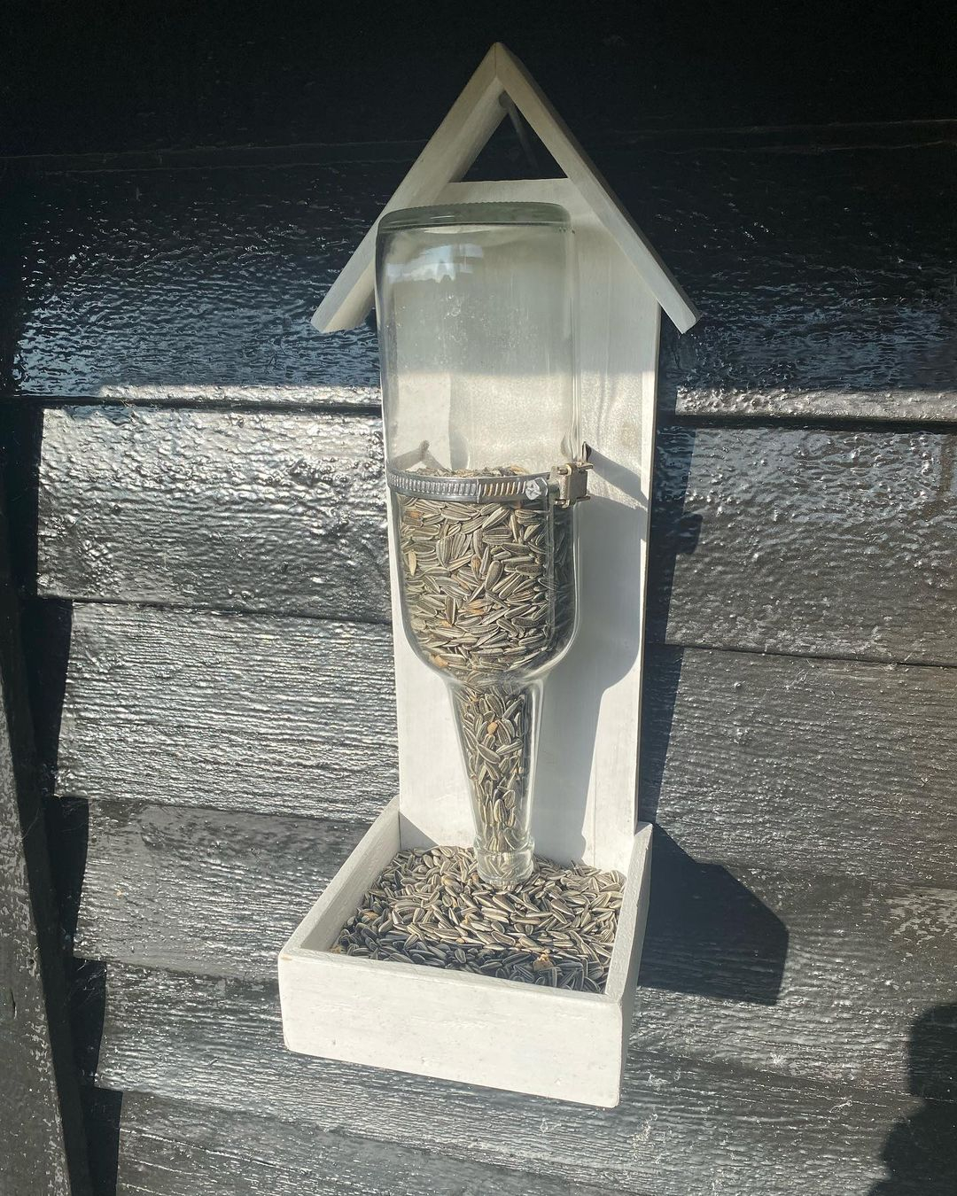 This bird feeder uses wood as an additional material. The glass is not colored. 