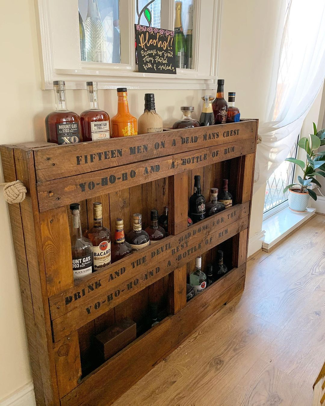 This one is a wine rack with a strong rustic characteristic. The wood is unfinished with some words printed there in a rustic style.