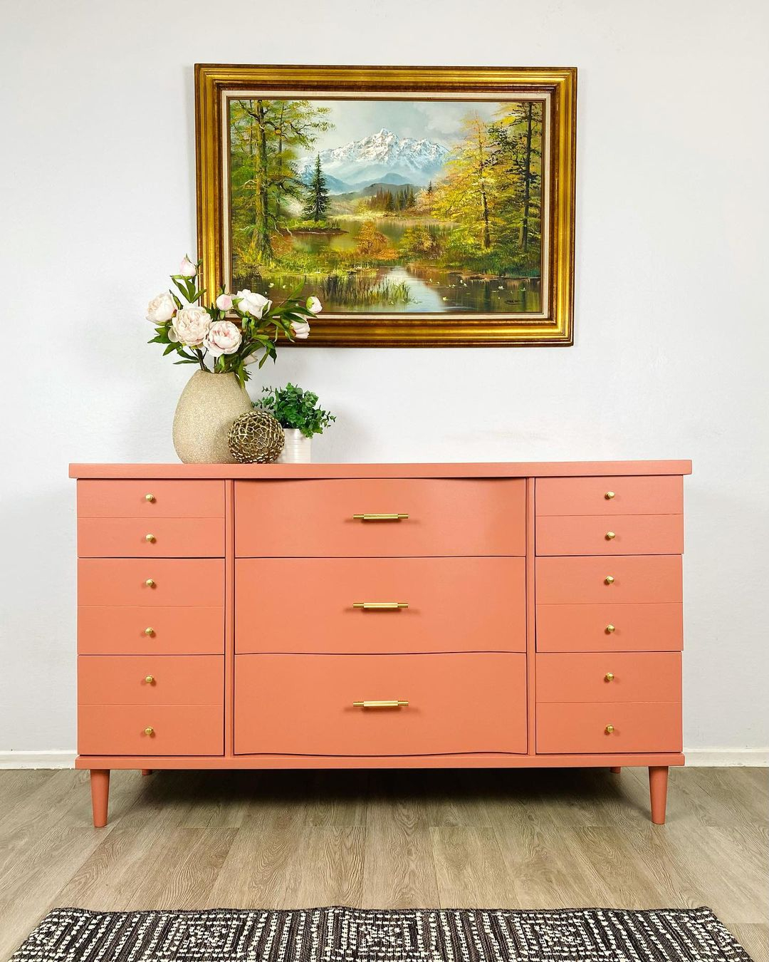 The bright color being applied here is the orange color which is applied to the dresser.