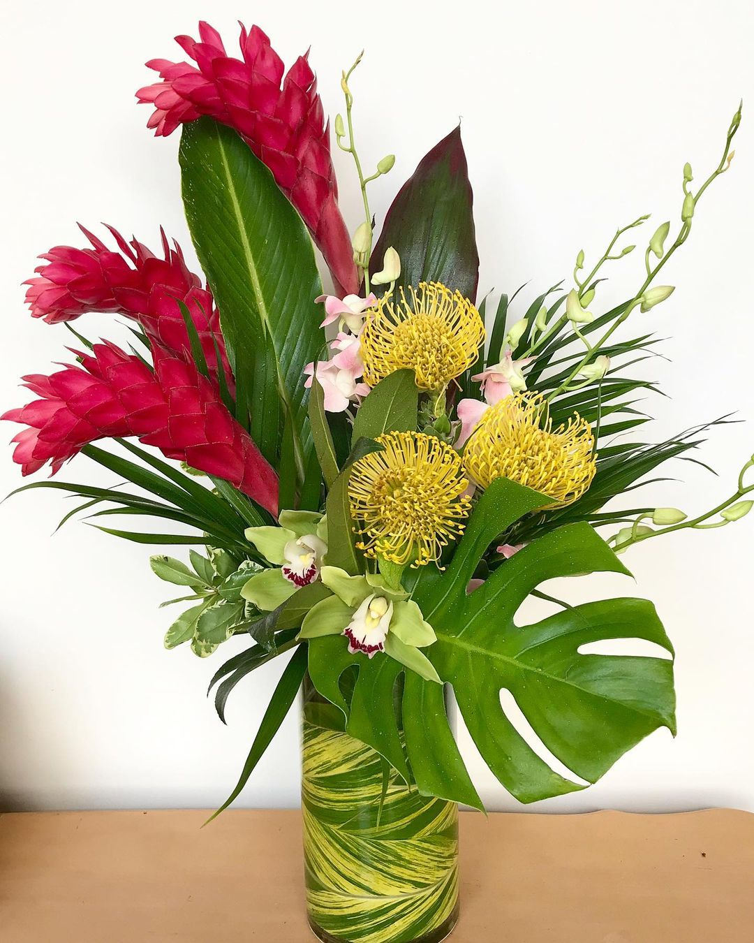 The flowers and foliage used here are all from tropical plants. You should also see the vase which is in foliage pattern.