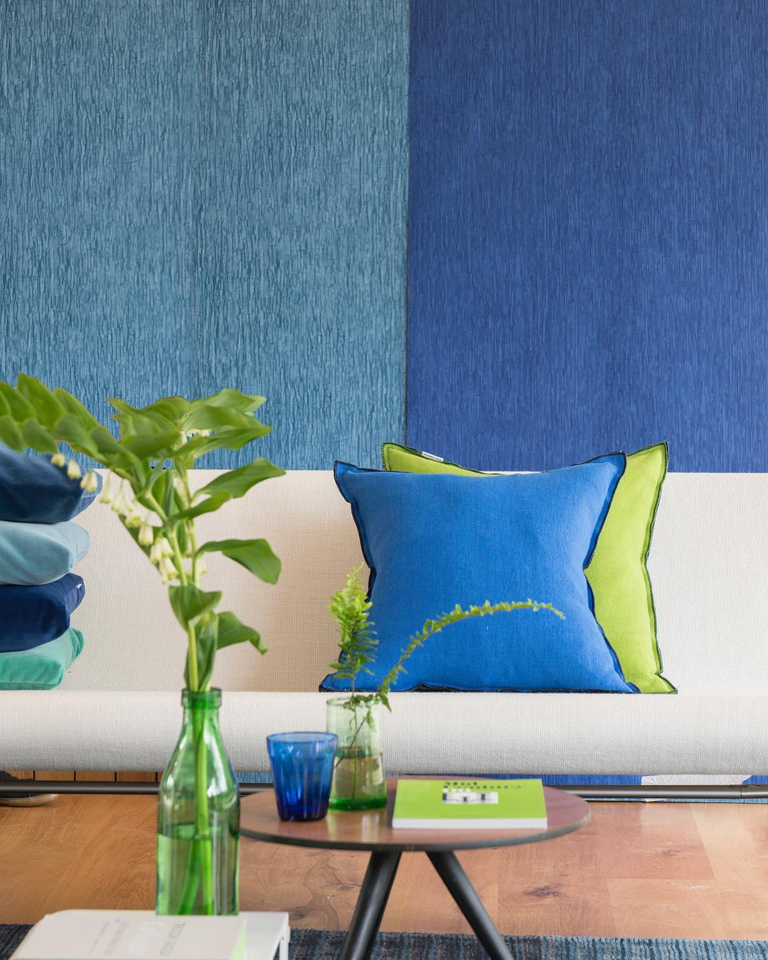 You can see the cushions and vases in this room. There are some matching colors applied. 